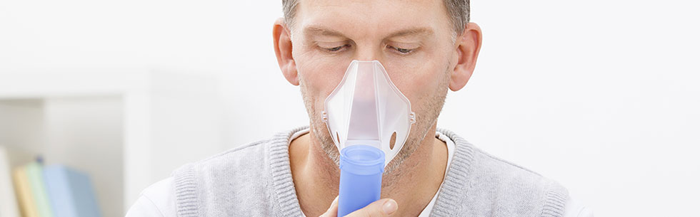 Man using oxygen equipment and nebulizer