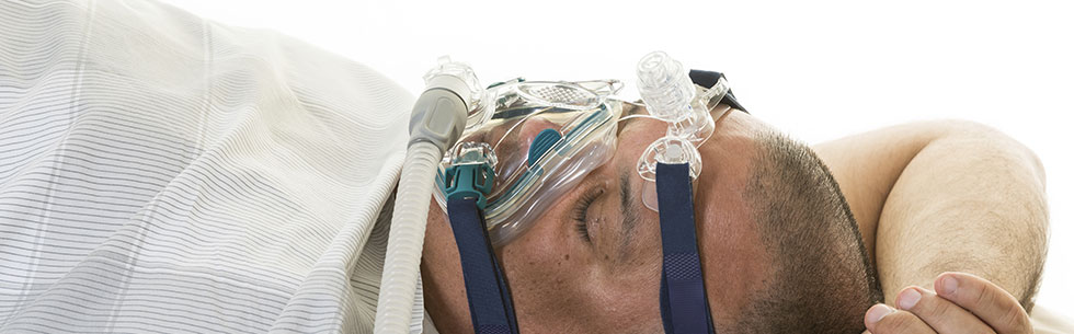 man using sleep apnea machine